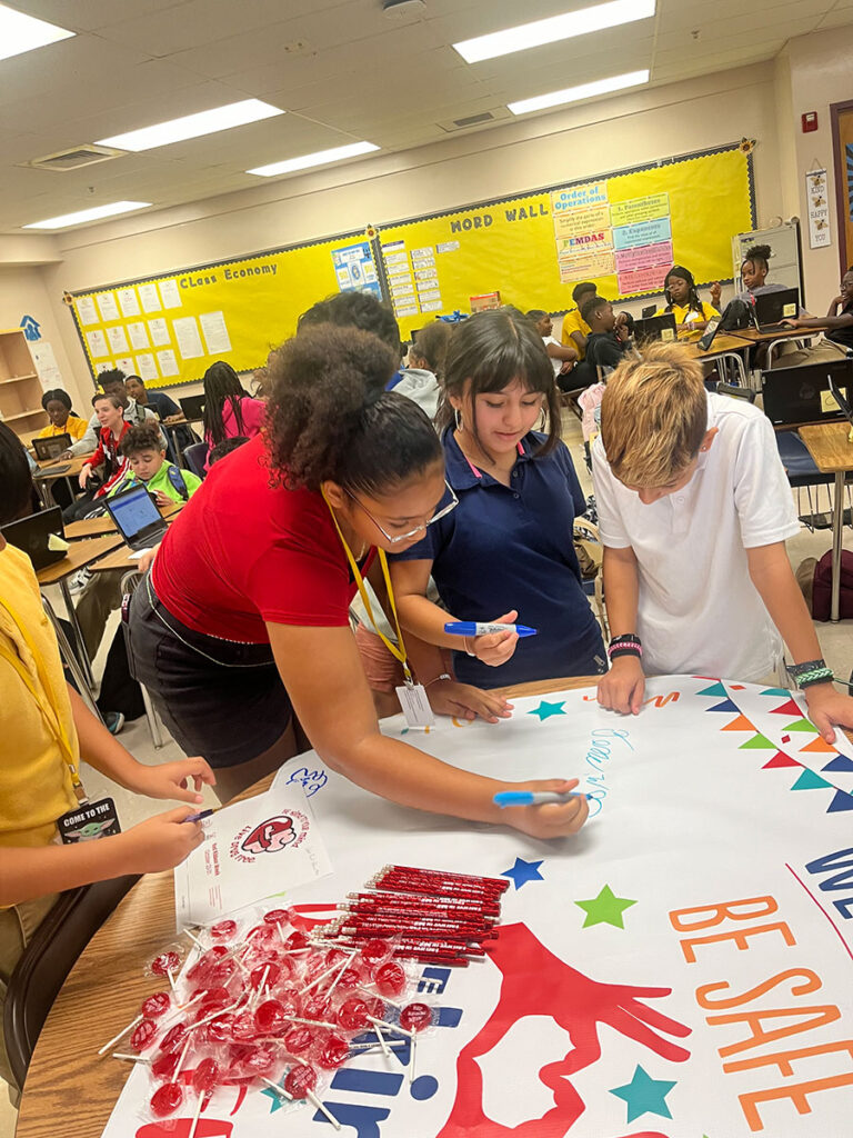 Students signing banner during session